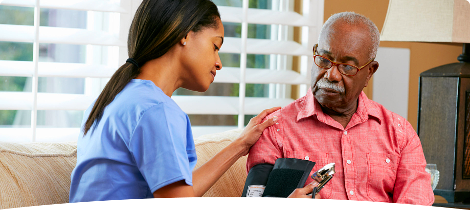 nurse checking old man's blood pressure